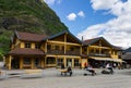 Historical houses of Flam, Norway with tourists walking by