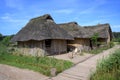 Historical houses from wood and clay with thatched roofs in the Viking village of Hedeby on the banks of the river Schlei in Royalty Free Stock Photo