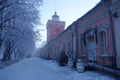 Historical jetty barracks and clock tower on cold winter morning in Suomenlinna fortress island.