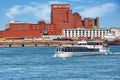 Historical Molson brewery building and a tour boat on saint Lawrence river in Montreal, Quebec, Canada