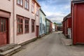 Quiet Roros lane showcases historical Norwegian architecture with tranquil, pastel-colored facades Royalty Free Stock Photo