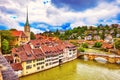 Historical Old Town of Bern city, tiled roofs, bridges over Aare river and church tower on dramatic sunset, Switzerland Royalty Free Stock Photo