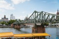 Historical pedestrian Eiserner Steg, Iron footbridge over the Main river, consists of riveted steel trusses, two bridge piers,