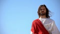 Historical personification of Jesus Christ looking after people against blue sky Royalty Free Stock Photo