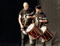 Boys with medieval costumes playing drums