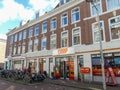 Historical red brick apartment building in The Hague with coop supermarket