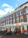 Historical red brick apartment building in The Hague with coop supermarket