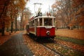 Historical red and white tram in Prage, tram station at the park, autumn scenery with colorgul trees and leaves. Royalty Free Stock Photo