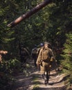 Historical reenactment of Russian Civil war in the Urals in 1918. Soldier of White Army goes on a forest road Royalty Free Stock Photo