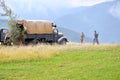 Historical reenactment of World War 2 battle - armored transport vehicle and soldiers dressed in german nazi uniforms