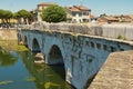 Historical roman Tiberius bridge over Marecchia river in Rimini, Italy.