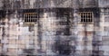 Historical sandstone convict built brick prison building, windows rusting security grill, wall background Royalty Free Stock Photo