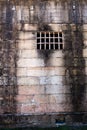 Historical sandstone convict built brick prison building, windows rusting security grill, wall background Royalty Free Stock Photo