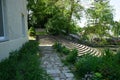 Historical semi-circular stone staircase in a park recreation area surrounded by flowers in June. Ruedersdorf near Berlin, Germany