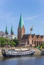 Historical ship and church along the river Weser in Bremen