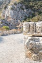 Historical Stone faces bas relief and ancient theater at Myra ancient city Royalty Free Stock Photo