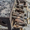 Historical tools of a blacksmith at a medieval market such as hammer, chisel, broach, chisel, beating plate, pestle, axe, pliers,