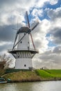 Historical white windmill along the Linge river in the village of Deil, Province Gelderland, The Netherlands Royalty Free Stock Photo