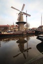 Historical windmill Roode Leeuw reflecting in the canal in Gouda Royalty Free Stock Photo