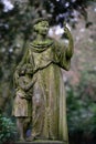 Historical woman figure with child in an old cemetery Royalty Free Stock Photo