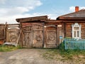 Historical wooden house with rickety carved gate. Village of Visim, Sverdlovsk region, Urals, Russia Royalty Free Stock Photo