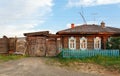 Historical wooden house with rickety carved gate. Village of Visim, Sverdlovsk region, Urals, Russia Royalty Free Stock Photo