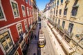 10 July 2017 - Lisbon, Portugal. Historical yellow tram in front of the Lisbon cathedral, Alfama, Lisbon, Portugal Royalty Free Stock Photo