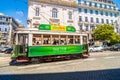 10 July 2017 - Lisbon, Portugal. Historical yellow tram in front of the Lisbon cathedral, Alfama, Lisbon, Portugal Royalty Free Stock Photo