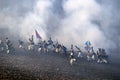 History fans in military costumes marching on the battlefield Royalty Free Stock Photo