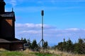 History and present, faith and science, historic wooden church in the company of modern army radar