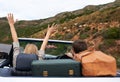 Hit the open road.... Rear view of a couple taking a road trip in a convertible.