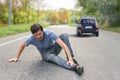 Hit and run concept. Injured man on road in front of a car Royalty Free Stock Photo