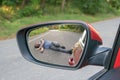 Hit and run concept. View on injured man on road in rear mirror of a car