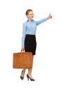 Hitch-hiking woman with suitcase Royalty Free Stock Photo