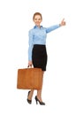 Hitch-hiking woman with suitcase Royalty Free Stock Photo