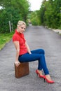 Hitchhiker with suitcase Royalty Free Stock Photo