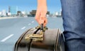 Hitchhiker with suitcase leaving the city Royalty Free Stock Photo