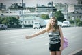 Hitchhiking girl with pink bag