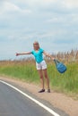 Hitchhiking girl votes on road