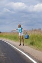 Hitchhiking girl votes on road