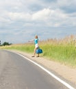 Hitchhiking girl votes on road