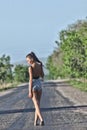 Hitchhiking model posing on motorway