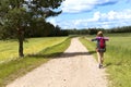 Hitchhiking road travel. Woman with a big backpack trying to stop a ride by thumbing