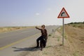 Hitchhiking woman Royalty Free Stock Photo