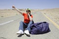 Hitchhiking woman Royalty Free Stock Photo