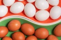 hite and red fresh chicken eggs are arranged on colored plates.