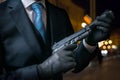 Hitman or assassin holds pistol with silencer in hands Royalty Free Stock Photo