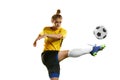 Hitting ball with leg. Young professional female football player in motion, training, playing football, soccer isolated Royalty Free Stock Photo