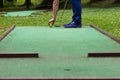 Hitting the ball on a mini golf course close up Royalty Free Stock Photo