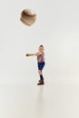 Hitting. Boy, child in classical retro clothes playing baseball over grey studio background. Concept of game, childhood